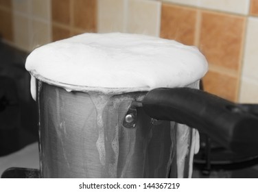 Milk Boiling Over A Pan