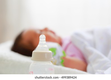 Milk bottle with baby sleeping