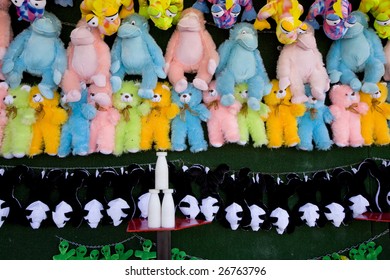 Milk Bottle Game At A Carnival With Furry Prizes.