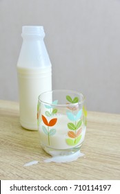 Milk Bottle, A Partial Filled Glass And Spilt Milk