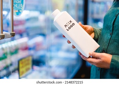 Milk box with empty logo bottle mockup package cardboard carton on woman pregnancy hand for shopping milk.Calcium in milk product.Grocery store.Check expired.juice package.Black American customer. 