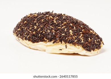Milk bread with a soft white interior, topped generously with chocolate sprinkles and a touch of white topping. Photographed against a clean white background.