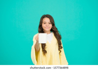 Milk For Breakfast. Happy Girl With Hot Dring In Cup. Good Morning. Small Kid Turquoise Wall. Little Girl Drink Cocoa Or Milk Before Sleeping. Cosy And Fluffy Pajama. Feeling Comfortable At Home.