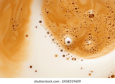 Milk in coffee close-up top view