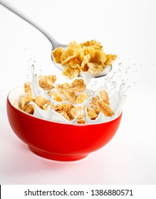 Milk and cornflakes splash, in a red bowl and a spoon with milk and cornflakes on a white background