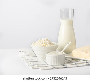 Milk, cottage cheese, sour cream, butteron a light background. Dairy nutrition