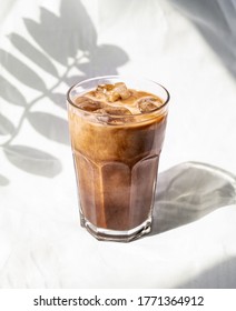 Milk cream iced cold brew coffee. Summer coffee cold drink cocktail with ice and milk. Aesthetic, minimalism.