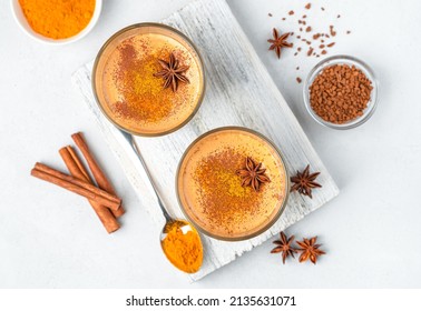 Milk dessert with cinnamon, coffee, turmeric and anise on a white background. Cinnamon pudding. Top view, close-up.