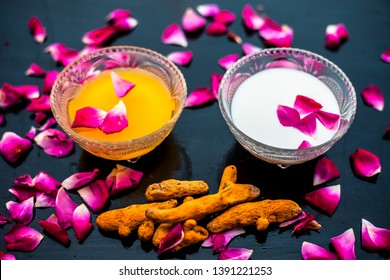 Milk Face Pack On Black Shiny Surface Consisting Of Raw Milk,turmeric Or Haldi And Badam In A Glass Bowl Along With Entire Raw Ingredients.