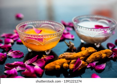 Milk Face Pack On Black Shiny Surface Consisting Of Raw Milk,turmeric Or Haldi And Badam In A Glass Bowl Along With Entire Raw Ingredients.