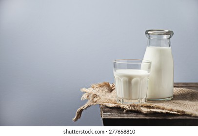 Milk in a glass bottle on wooden background - Powered by Shutterstock