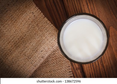 Milk In A Glass On A Wooden Table  Top View