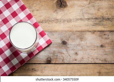 Milk In A Glass On A Wooden Table Top View