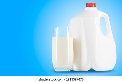 Milk. Glass Of Milk And One Gallon Of Whole Milk On Blue Background. Organic Milk Product. White Plastic Bottle One Gallon Or 3.78 Liter.