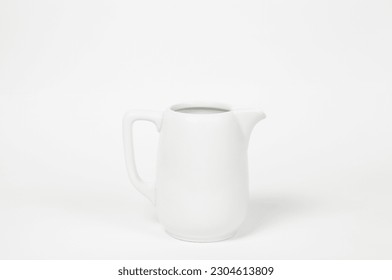 Milk jug on white background. Porcelain sauce boat, pitcher, creamer or ceramic gravy boat. Space for text, for advertising, banner, signboard, menu and printed materials - Powered by Shutterstock