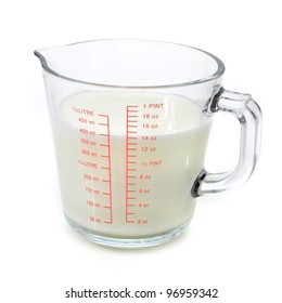 Milk In Measuring Cup On White Background