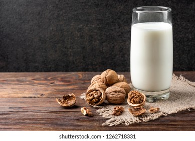  Walnut milk on dark wooden background.