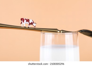 Milk On The Spoon And Miniature Cow On The Spoon