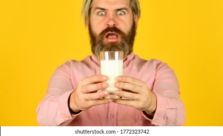 Milk Pasteurization in Dairy Processing Plant. selective focus. surprised man hold glass of milk. pasteurized milk. Man offer tasty vegan glass. buy milk in supermarket.