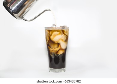 Milk Pour Over Glass Of Ice Coffee In White Background