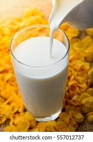 Milk Pouring From A Jug Into A Glass 