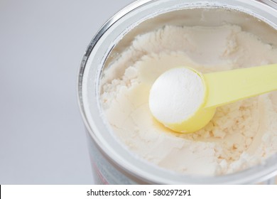 Milk Powder For Baby In Measuring Spoon On Can.