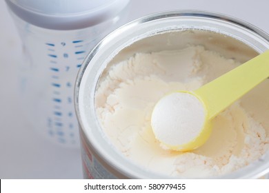 Milk Powder For Baby In Measuring Spoon On Can.