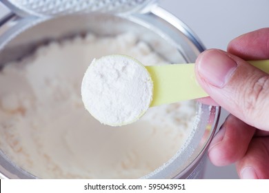 Milk Powder For Baby In Spoon Measure On Can.