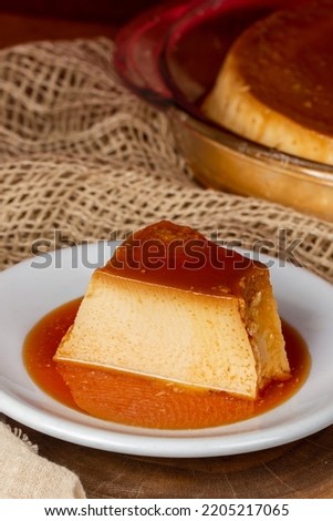 Milk pudding on white plate in rustic setting