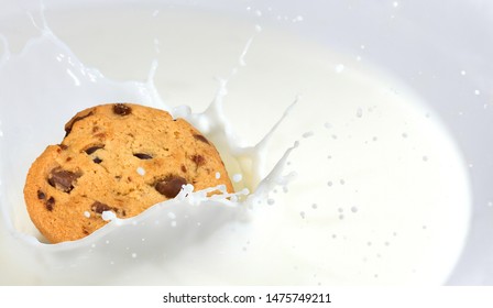 Milk Splash. Delicious Cookie Dunk In A Bowl With Milk. Beautiful Background With Space For Your Text.