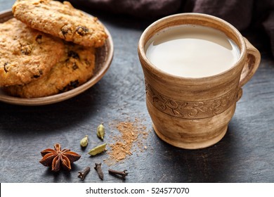 Milk tea chai latte traditional homemade refreshing morning breakfast organic healthy hot beverage drink with natural aroma spices blend, cardamon, anise, cinnamon, in rustic ceramic cup on