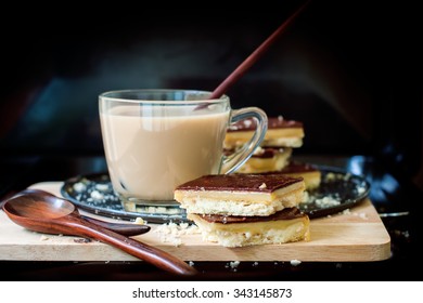 Milk Tea With Chocolate Caramel Cookies On Black Background. Homemade Baking