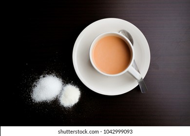 Milk Tea With Sugar,creamer And Tea Leaf On The Wooden Table.Top View.