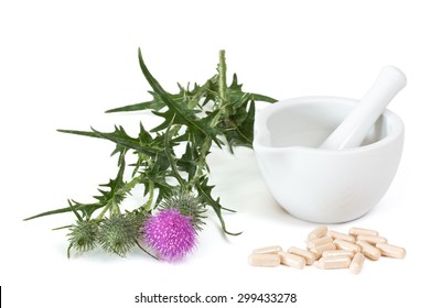 Milk Thistle And Capsules Near Mortar And Pestle On White Background