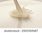 Milk or yoghurt splash from pouring dairy product close up.