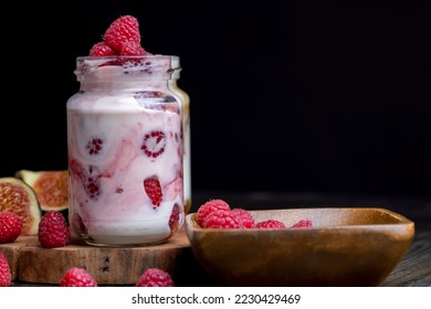 Milk yogurt with raspberries, layered yogurt with raspberry flavor and fresh berries - Shutterstock ID 2230429469
