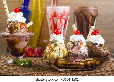 Milkshake, Banana Split And Sundae. Ice Cream Flavors With Chocolate And Strawberry Syrup And Whipped Cream.