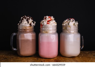 Milkshake, Banana Split And Sundae. Ice Cream Flavors With Chocolate And Strawberry Syrup And Whipped Cream.