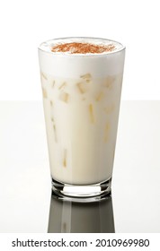 Milkshake Vanilla Iced With Ice Cream, Milk Froth And Ice Cubes, Sprinkled With Cinnamon In A Glass In European Style On A White Background