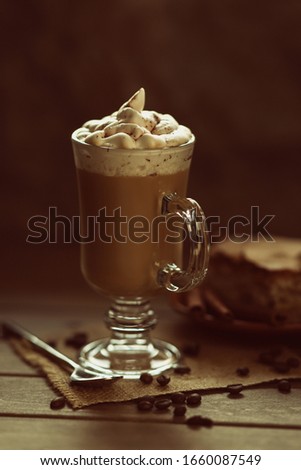 milky coffie with chokolate,cream,coffie beans.spoon,cake