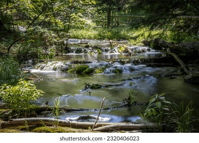 The milky waters of Weaver's Creek flow gently over the rocks in Harrison Park in Owen Sound, Ontario.