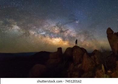 Milky Way At Balanced Rock, Big Bend National Park, Texas USA. Constellation And Galaxy. Human Reaching For Stars.