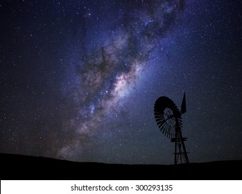 The milky way core rises above a windmill in the Karoo desert, South Africa. - Powered by Shutterstock