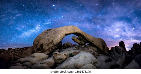 The Milky Way formed over Joshua Tree's Arch Rock.  This is a panoramic perspective requiring eight stitched images to get a 180-degree perspective. - Powered by Shutterstock