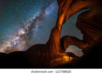 Milky Way Galaxy behind Double Arch sandstone rock formation in Arches, National Park, Utah