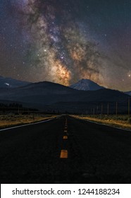 Milky Way Galaxy On A Clear Night Over An Empty Two Lane Highway In Utah Wasatch National Forest East Of Park City Oakley In The Uintah-Wasatch Basin On Mirror Lake Highway