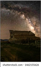 Milky Way Galaxy Rising From Behind An Isolated And Abandoned Barn House In The Middle Of Utah Desert,USA