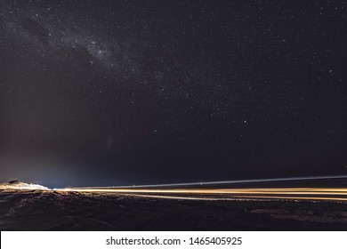 Milky way glows in a starry night sky in Broome. There is also a car light trail due to the long exposure effect. Australian night sky is a must for astronomy lovers. South hemisphere constellations - Powered by Shutterstock