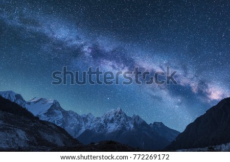 Milky Way and mountains. Amazing scene with himalayan mountains and starry sky at night in Nepal. Rocks with snowy peak and sky with stars. Beautiful Himalayas. Night landscape with bright milky way