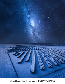 Milky Way Over Photovoltaic Farm At Night. Alternative Energy In Winter, Poland. Pure Energy From Sun.